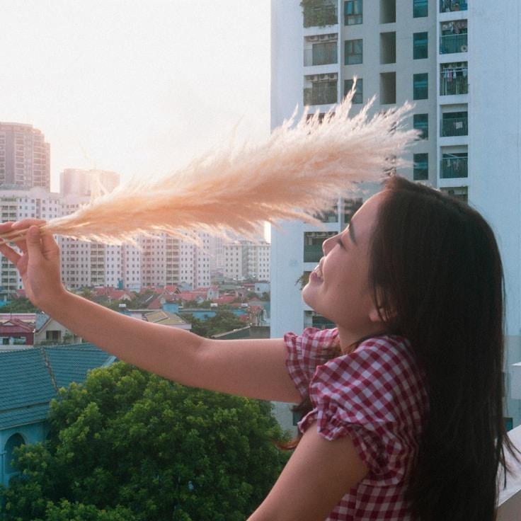 Avery Chen, Lead Design Curator at Creek Harbor Mead, reviewing corporate floral arrangements